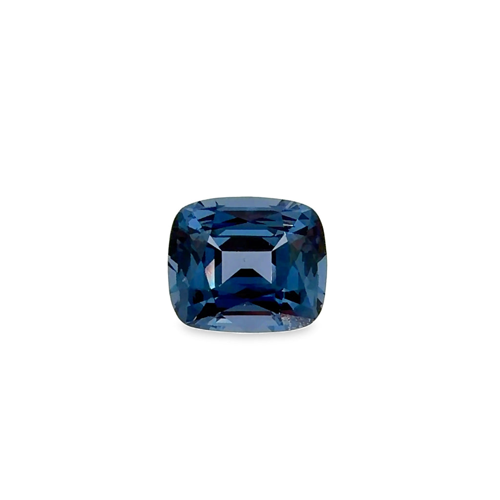 A cushion-cut blue spinel gemstone with a faceted square shape, centered on a plain white background.