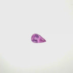 A pear-cut pink gemstone with faceted cuts, centered on a solid white background, spinning 360 degrees.